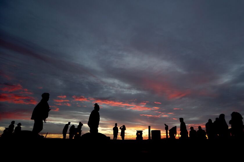 LONG BEACH, CA. - DEC. 27, 2020. A small crowd of peopke take in the sunset from the top of Signal Hill on (Sunday, DSec. 27, 2020. Luis Sinco/Los Angeles Times)