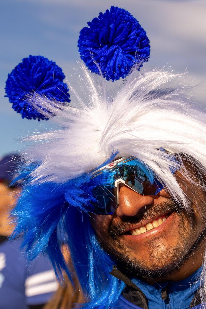 Los Angeles' Vicente Morales sports a wig and pom-poms on a hike in Dodger blue hiking gear. 