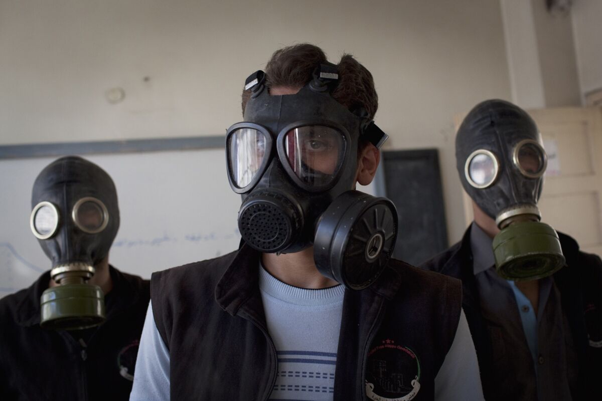 Volunteers in the northern Syrian city of Aleppo wear gas masks during a class on how to respond to a chemical attack.