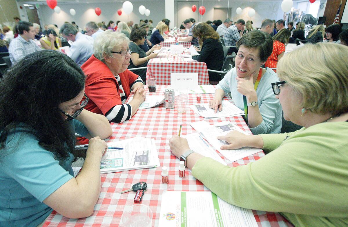 Members of the "Bibliophiles" team consider answers as they go through the test during the Smart-a-Thon at USC Verdugo Hills Hospital in Glendale on Wednesday, March 16, 2016. The annual event is in its 28th year, sponsored by the Mary Pinola & Crescenta Valley Chamber Education Fund.