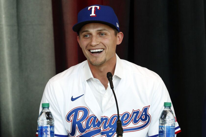 New Texas Rangers infielder Corey Seager speaks at a press conference at Globe Life Field Wednesday, Dec. 1, 2021, in Arlington, Texas. The Texas Rangers have finalized the contracts for their new half-billion dollar middle infield, wrapping up their deals Wednesday, Dec. 1, 2021 with two-time All-Star shortstop Corey Seager and Gold Glove second baseman Marcus Semien.(AP Photo/Richard W. Rodriguez)