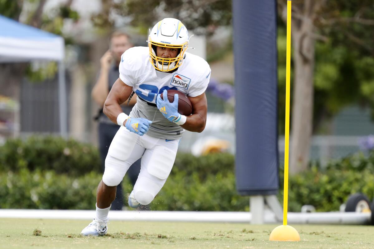 Chargers running back Austin Ekeler carries the ball in drills during training camp in Costa Mesa on Aug. 6.