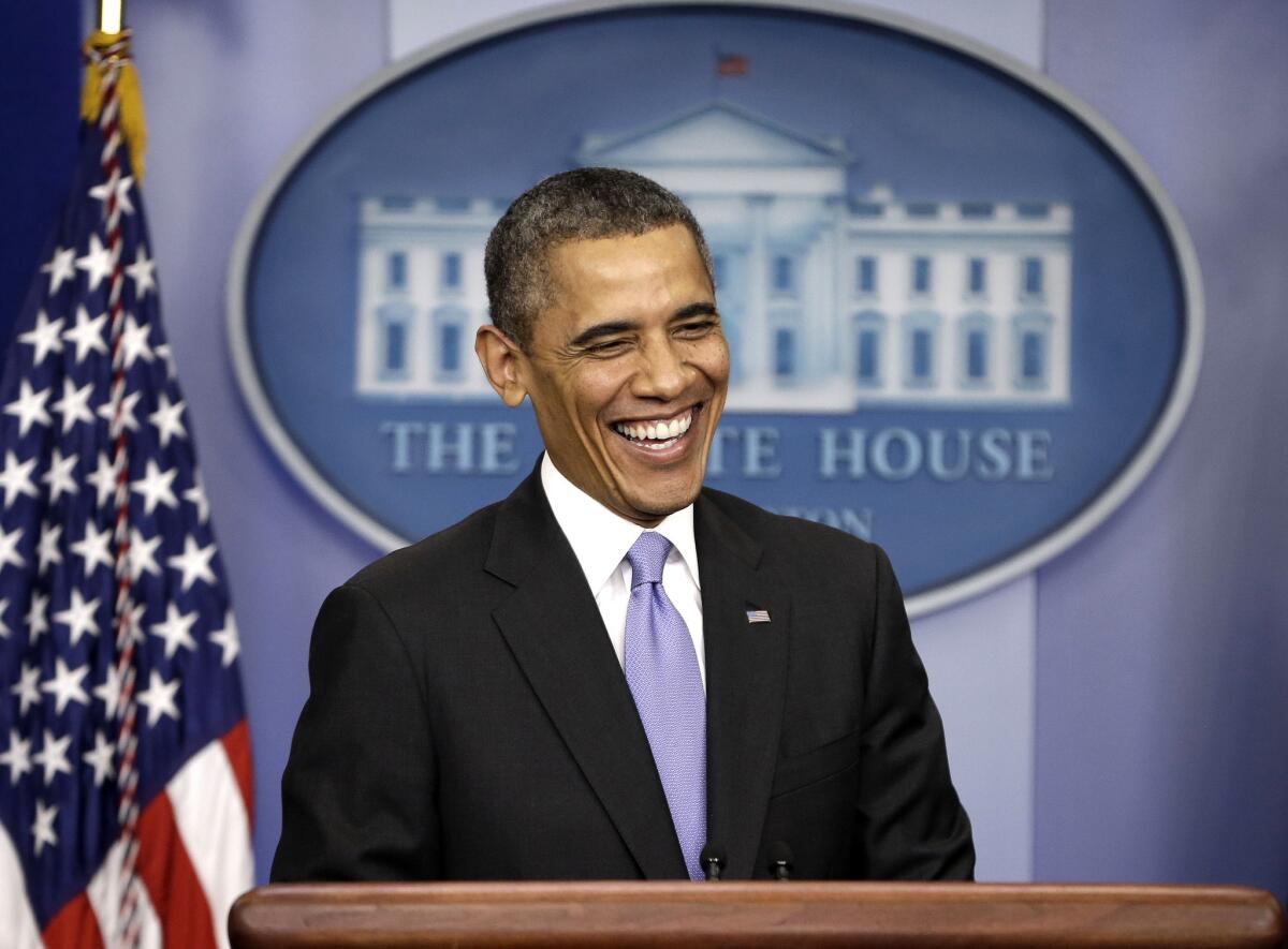President Obama smiles during an end-of-the year news conference at the White House on Friday. Obama and his family will spend the holidays in Hawaii.