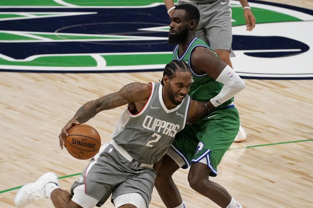 Clippers' Kawhi Leonard drives to the basket as Dallas Mavericks' Tim Hardaway Jr.