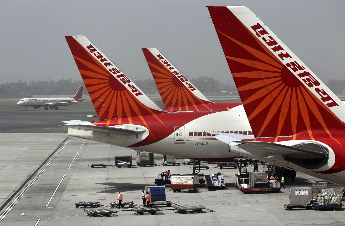 FILE - In this April 29, 2011 file photo, passenger jets from Air India, India's national carrier, stand at Indira Gandhi International Airport in New Delhi, India. India’s government says it has received “multiple expressions of interest” in buying its 100% stake in the debt-laden national carrier Air India to shore up falling government revenues after an initial attempt in 2018 failed to attract any bidders. The deadline for submission of formal bids was Monday, Dec. 14, 2020, and the government is expected to announce the qualified bidders on Jan. 5. It did not reveal the identity of the bidders or the number of bids received. (AP Photo/Kevin Frayer, File)