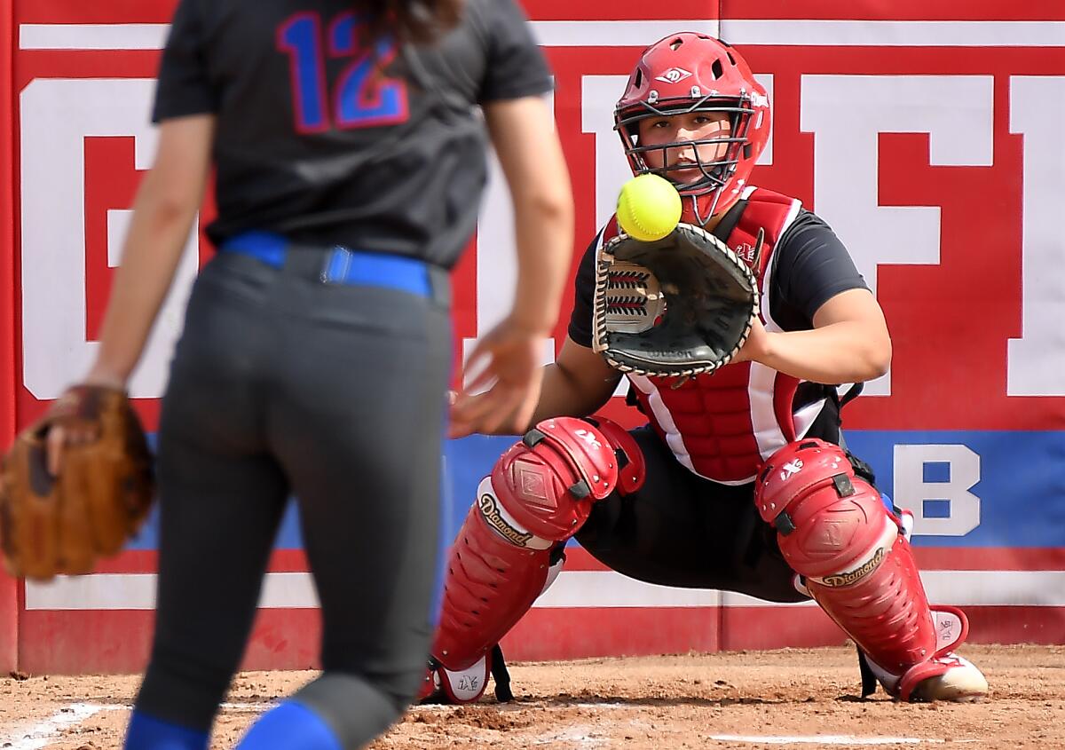 Los Alamitos catcher Sophia Nugent warms up before a game.