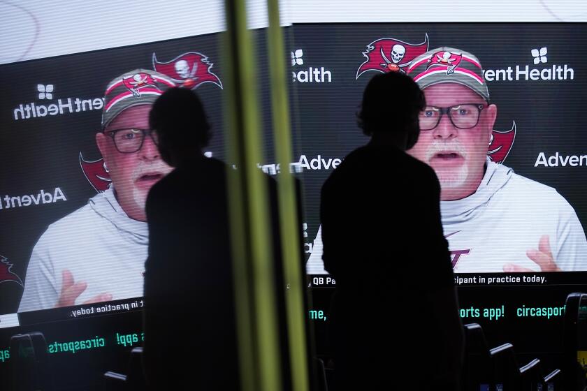 Tampa Bay Buccaneers head coach Bruce Arians is displayed on a monitor at the Circa resort and casino sports book, Wednesday, Feb. 3, 2021, in Las Vegas. (AP Photo/John Locher)