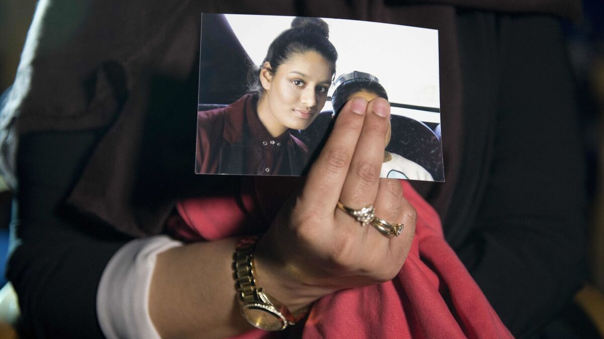 Renu Begum, the eldest sister of Shamima Begum, holds a picture of the girl during an interview in London in February 2015.
