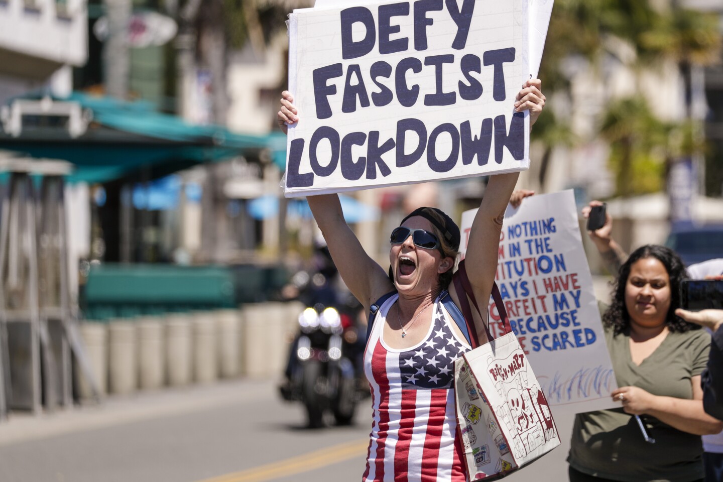 HUNTINGTON BEACH, CA - APRIL 17: Sarah Mason, from Covina, at a rally against the lockdown due to coronavirus pandemic. A big number of Trump supporters rally on Main Street against business closure due to COVID-19 pandemic. Huntington Beach, CA. (Irfan Khan / Los Angeles Times)
