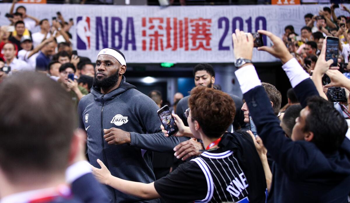 Lakers star LeBron James runs onto the court before an exhibition game against the Brooklyn Nets in China on Oct. 12.