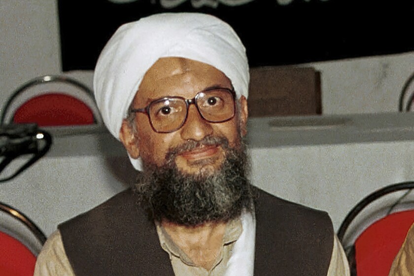 A bearded, turbaned man wearing glasses 