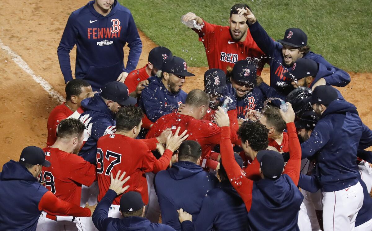 Christian Vazquez is mobbed by his Red Sox teammates after hitting a walk-off home run.