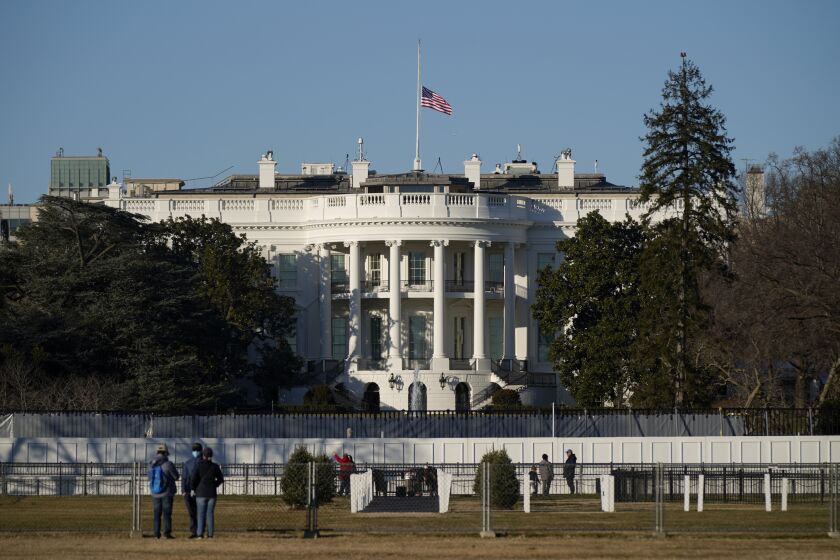 An American flag flies at half-staff above the White House in Washington, Sunday, Jan. 10, 2021. (AP Photo/Patrick Semansky)