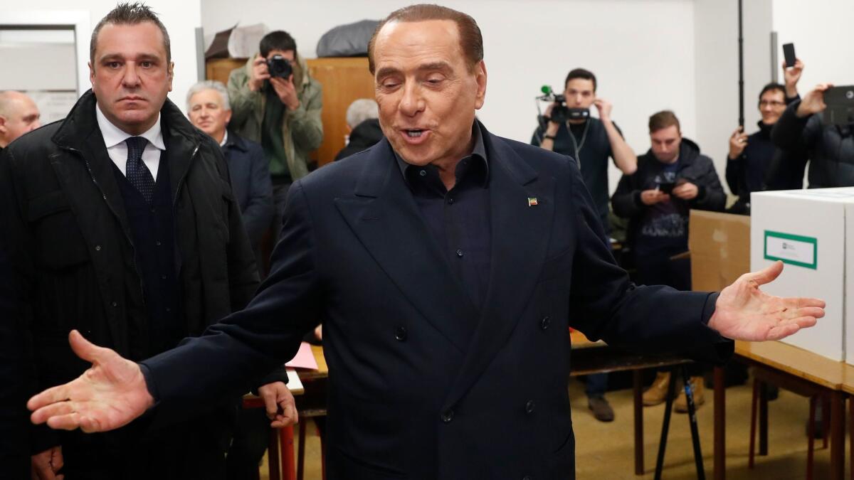 Former Italian Prime Minister Silvio Berlusconi of the Forza Italia party arrives at a polling station in Milan on March 4, 2018.