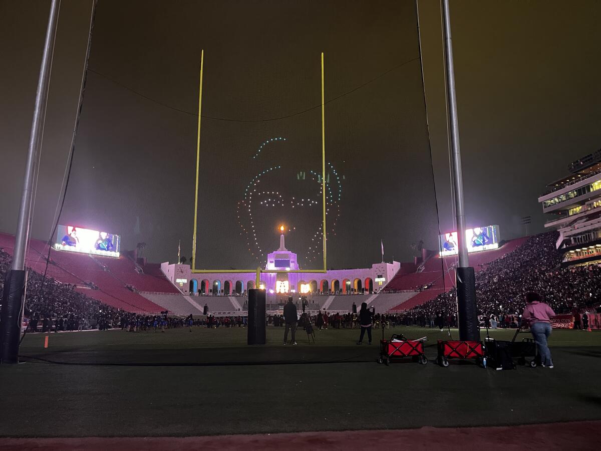 Drones illuminated outlines of the Black Eyed Peas during the halftime show of the East L.A. Classic on Friday night.