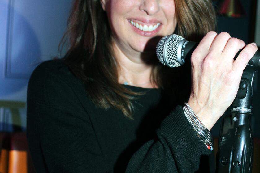 In happier times, Elissa Glickman takes over the mic at Comedy Night at Glendale's Greyhound Bar & Grill in December, 2019. (Photo by Ruth Sowby Rands)