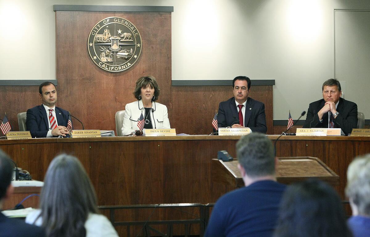 Glendale's new mayor, Paula Devine, center, starts her term on Tuesday, April 5, 2016.
