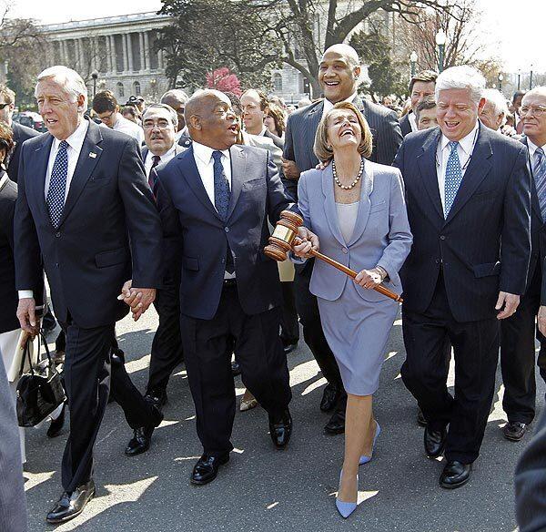 House Speaker Nancy Pelosi walks into the Capitol with, from left, Majority Whip Steny H. Hoyer (D-Md.), Rep. John Lewis (D-Ga.) and Democratic Caucus Chairman John B. Larson (D-Conn.). Pelosi carries a gavel used to pass Medicare legislation in 1965. Full story