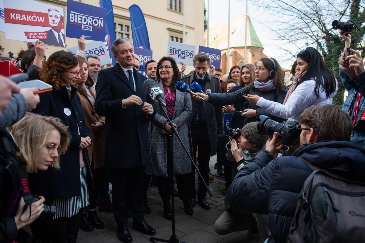 Robert Biedron speaks to the media before rallying with supporters in Krakow, Poland.