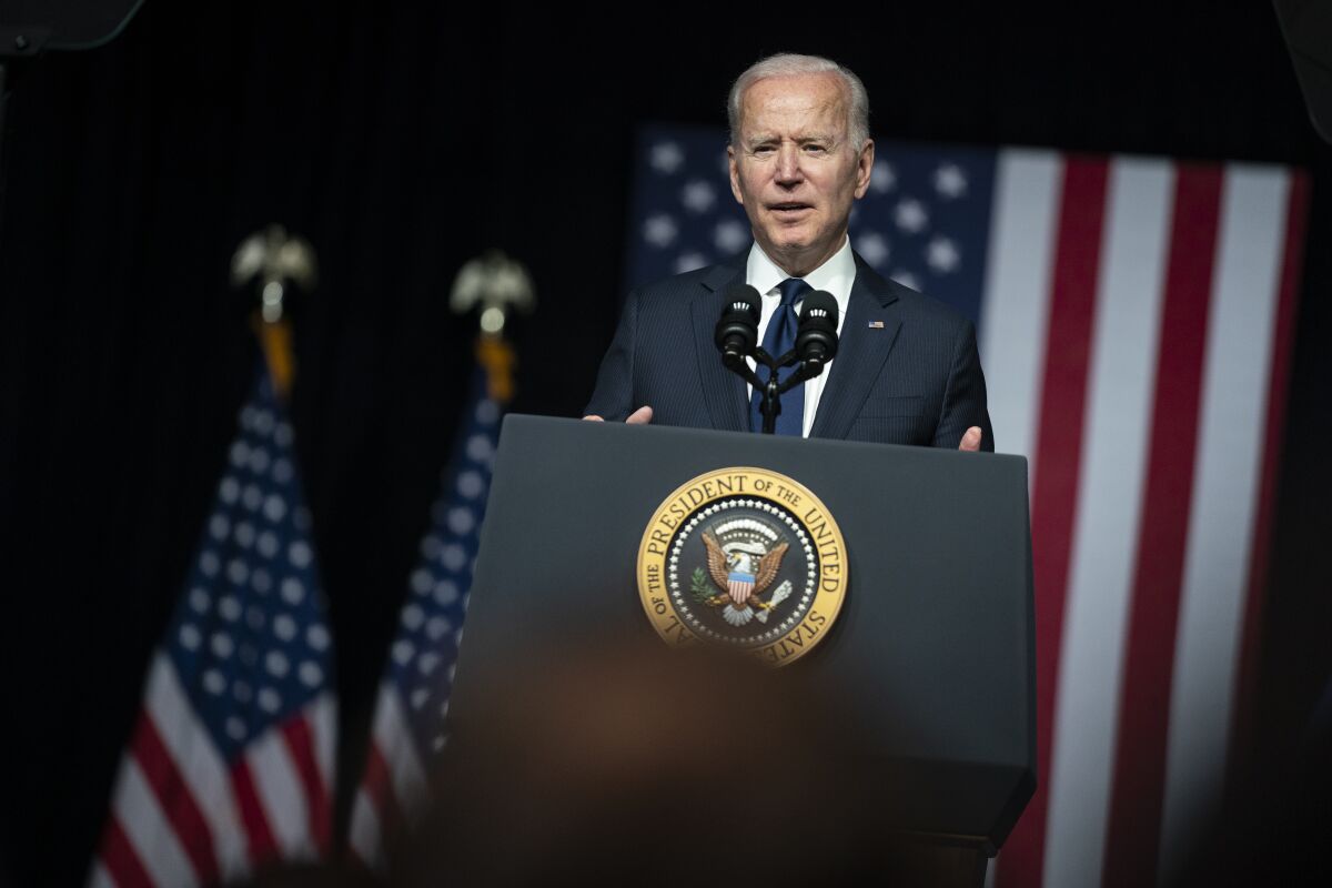 President Biden speaks at a lectern with the presidential seal.