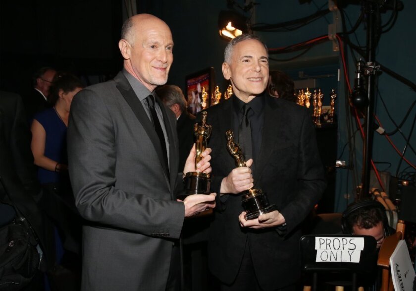 Oscar telecast executive producers Craig Zadan, left, and Neil Meron with statuettes backstage at the Feb. 24 gala.
