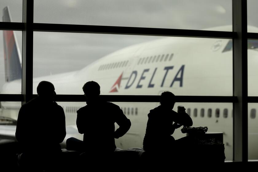 Delta Air Lines passengers wait for flights in Detroit. The airline has requested trademark protection for the slogan "The World's Most Trusted Airline."