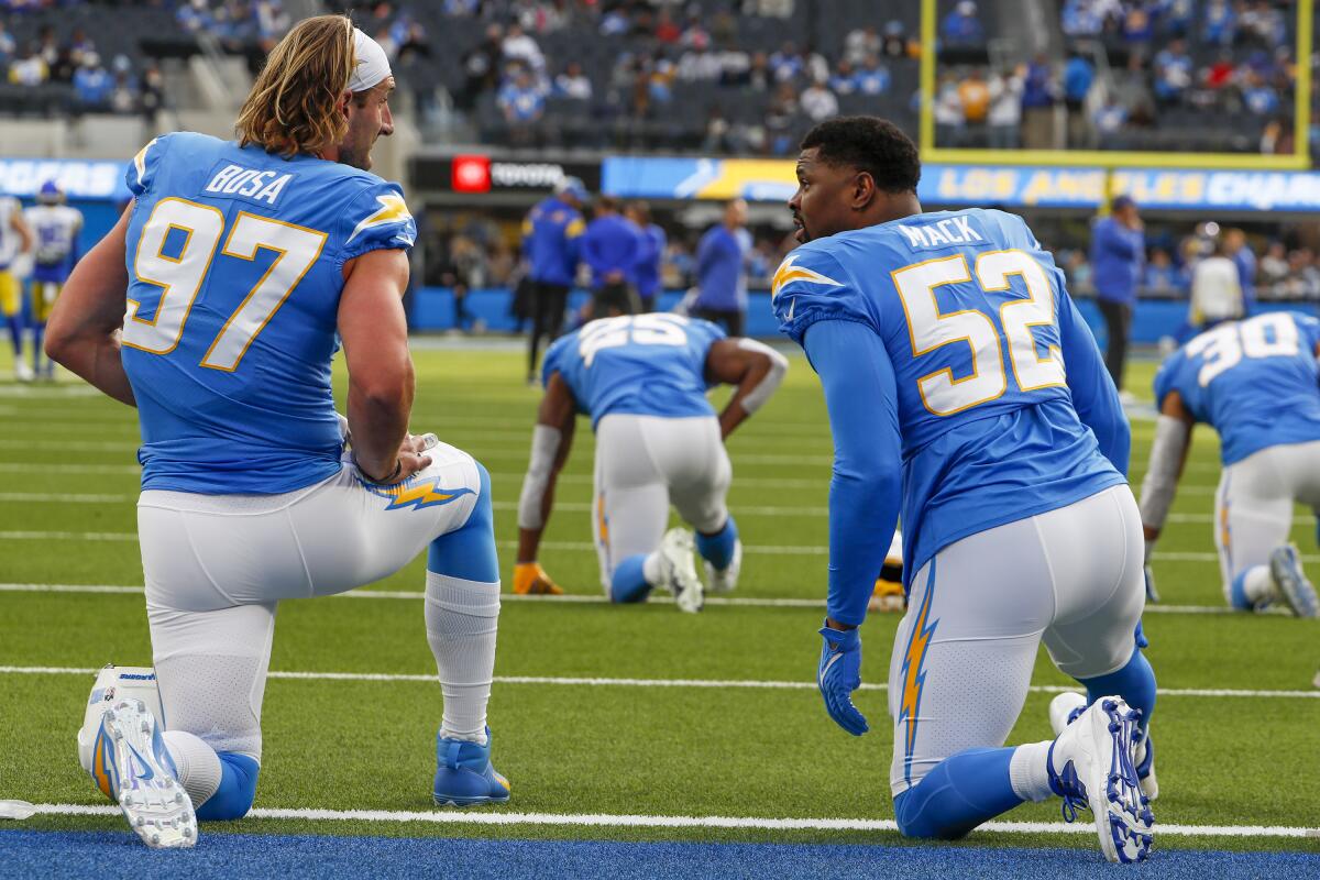 Chargers defensive stars Joey Bosa, left, and Khalil Mack talk before their game against the Rams.