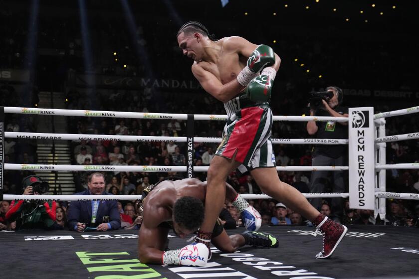 David Benavidez knocks down Demetrius Andrade in a super middleweight title boxing match, Saturday, Nov. 25, 2023, in Las Vegas. (AP Photo/John Locher)