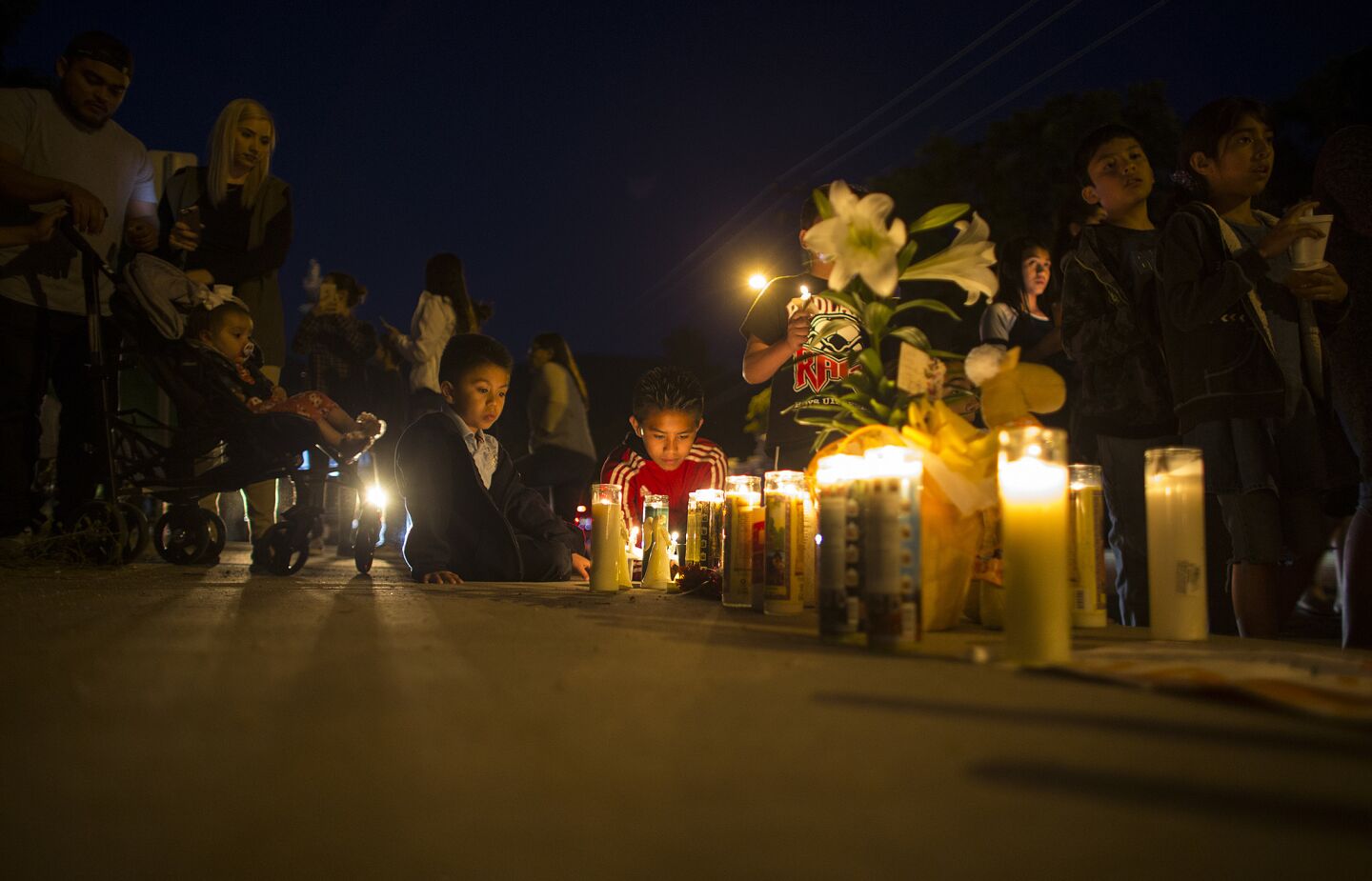 Students spend time at a memorial near North Park Elementary after a prayer vigil.