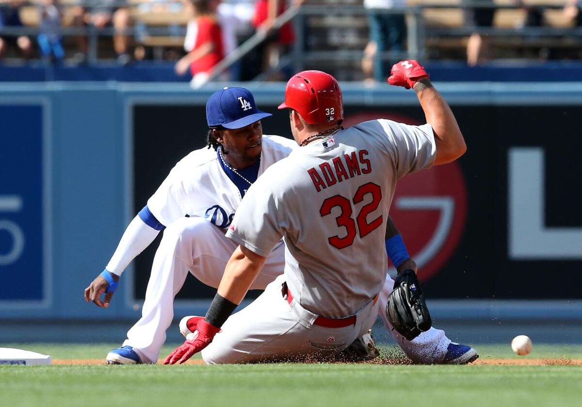 St. Louis' Matt Adams slides into second against Hanley Ramirez, who left Saturday's game in the second inning with an injured left calf.