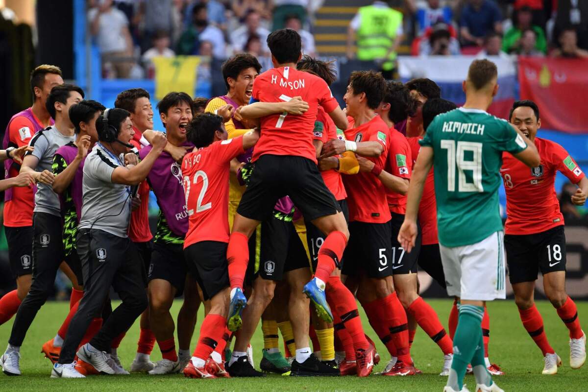 South Korea's Kim Young-gwon celebrates with teammates after scoring a goal against Germany.