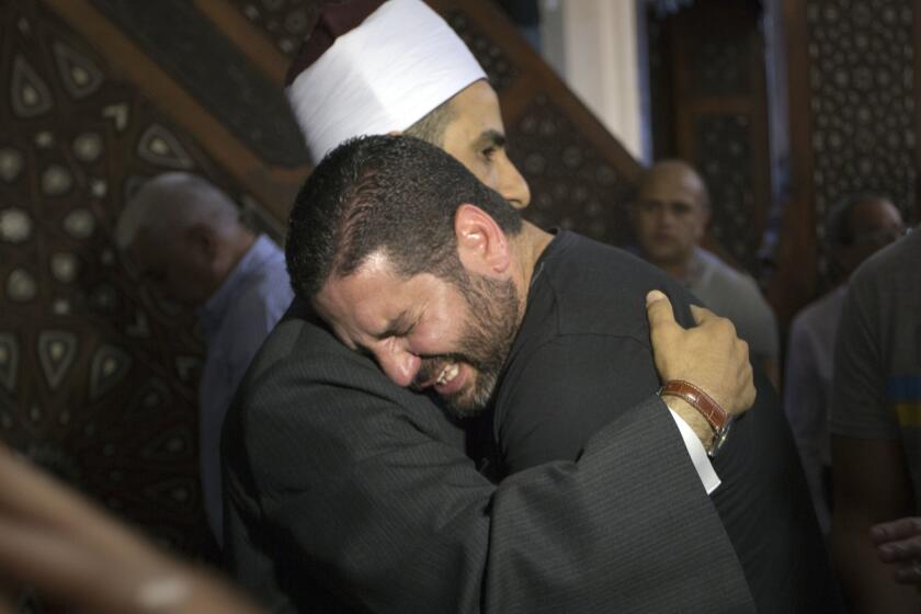 The imam of Cairo's Al Thawrah Mosque, Samir Abdel Bary, comforts Osman Abu Laban, who lost four relatives in the EgyptAir crash.