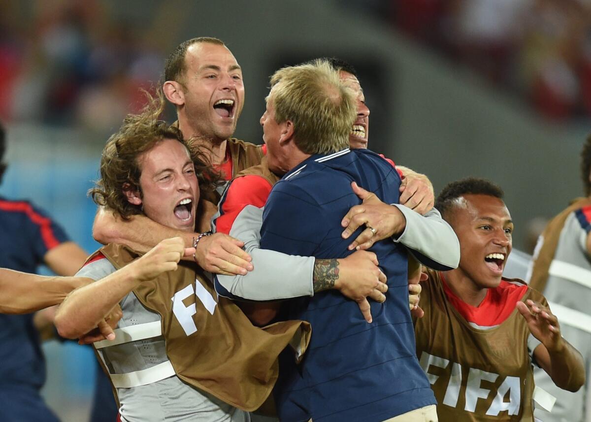 Juergen Klinsmann celebrates with his team after the US beat Ghana, 2-1, at the World Cup.