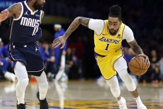 Los Angeles, CA - January 17: Lakers point guard D'Angelo Russell, #1, right, drives to the hoop as Mavericks point guard Kyrie Irving, #11, defends in the first half at Crypto.com Arena in Los Angeles Wednesday, Jan. 17, 2024. Lakers win 110-127. (Allen J. Schaben / Los Angeles Times)