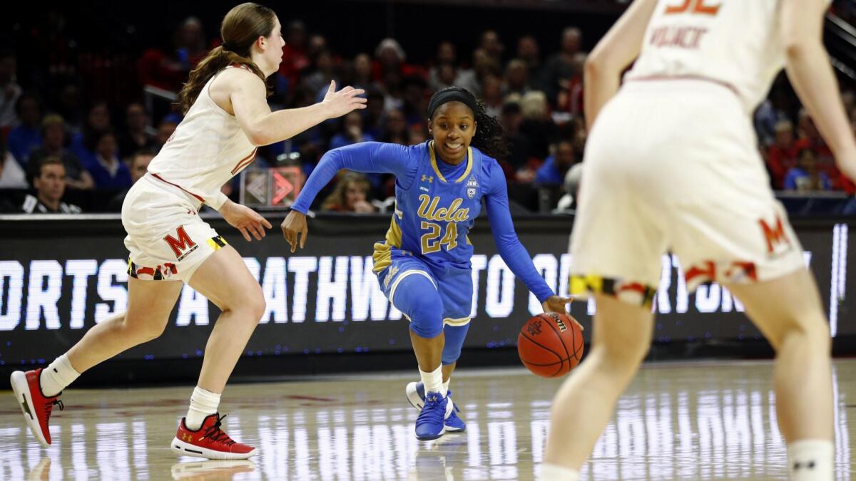 UCLA guard Japreece Dean drives against Maryland guards Taylor Mikesell, left, and Sara Vujacic (32) during the first half of a second-round game in the NCAA women's tournament on Monday in College Park, Md.
