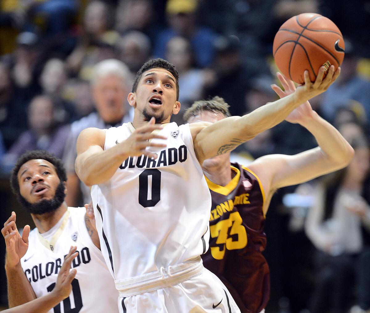 Colorado guard Askia Booker drives to the hoop during a game against Arizona State on March 1.