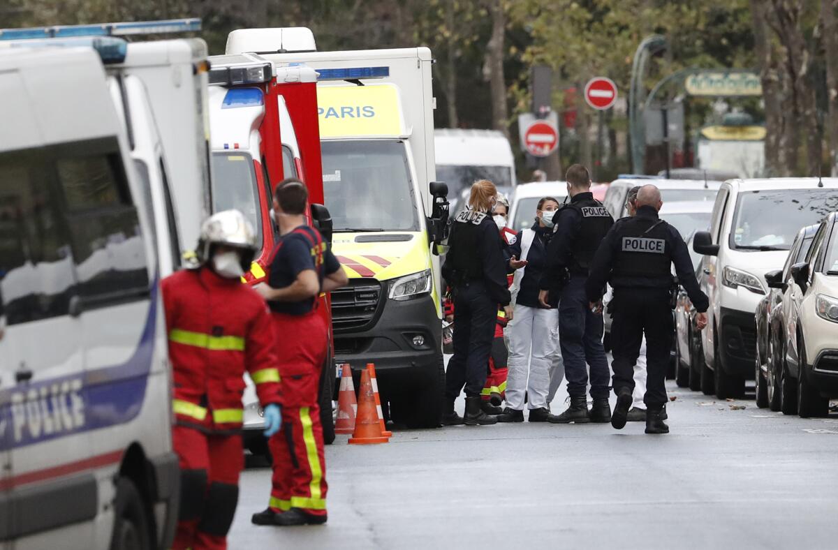 Police and rescue workers near the scene of a Paris knife attack Friday