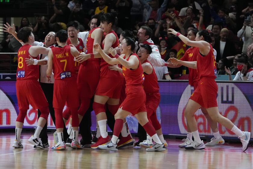 China celebrate after defeating Australia in their semifinal at the women's Basketball World Cup in Sydney, Australia, Friday, Sept. 30, 2022. (AP Photo/Mark Baker)