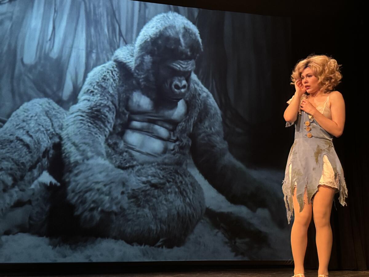 King Kong is performed live backstage so that he can appear larger-than-life on the screen behind Ann Darrow.
