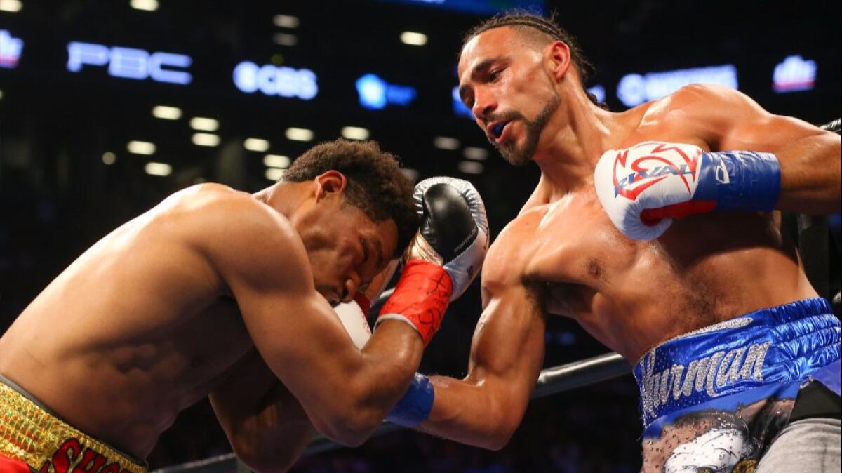 Keith Thurman hits Shawn Porter with a right hand during their 12 round welterweight title bout on June 25.