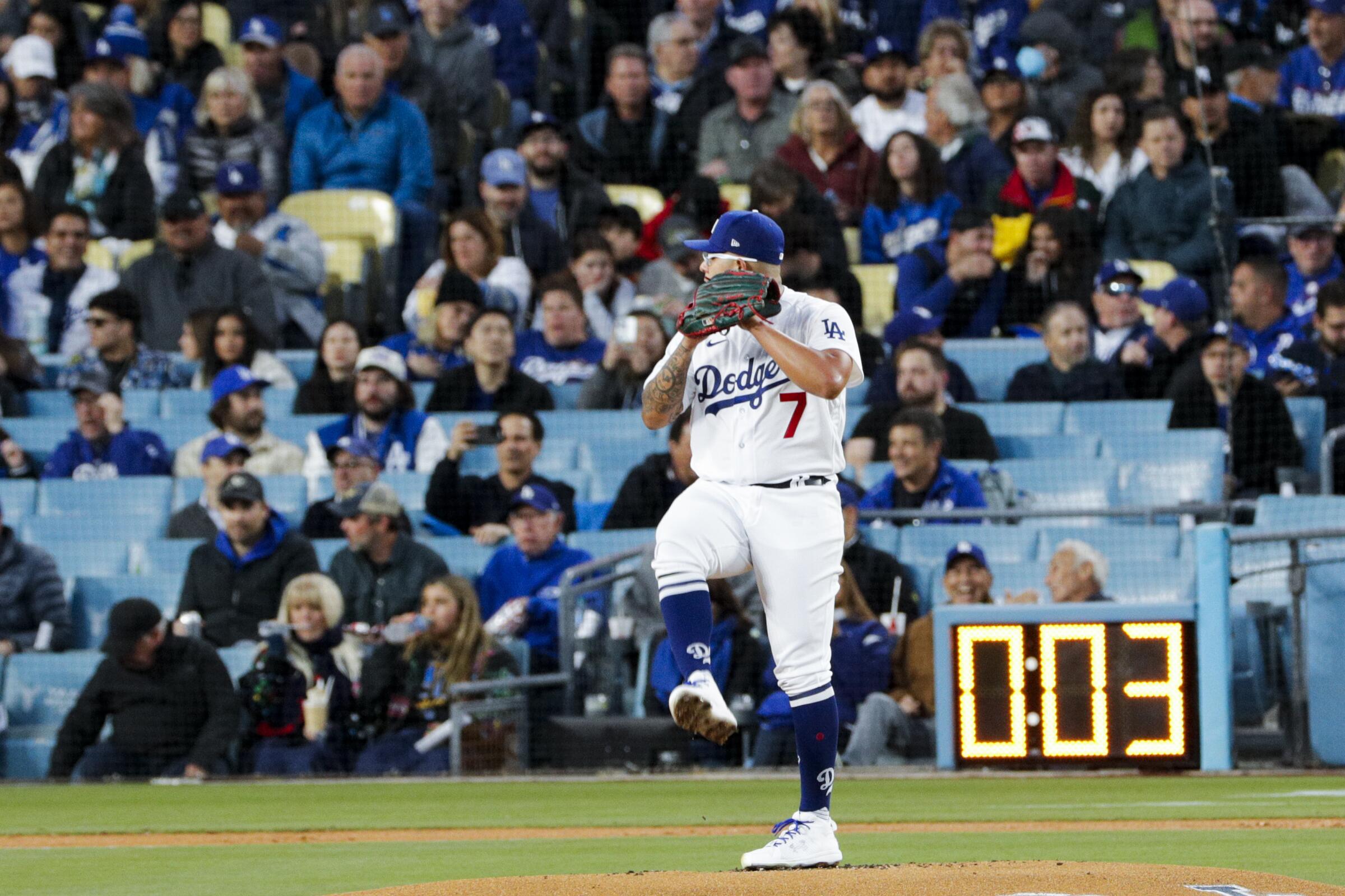 Dodgers starting pitcher Julio Urías delivers a pitch with the pitch clock at three seconds.
