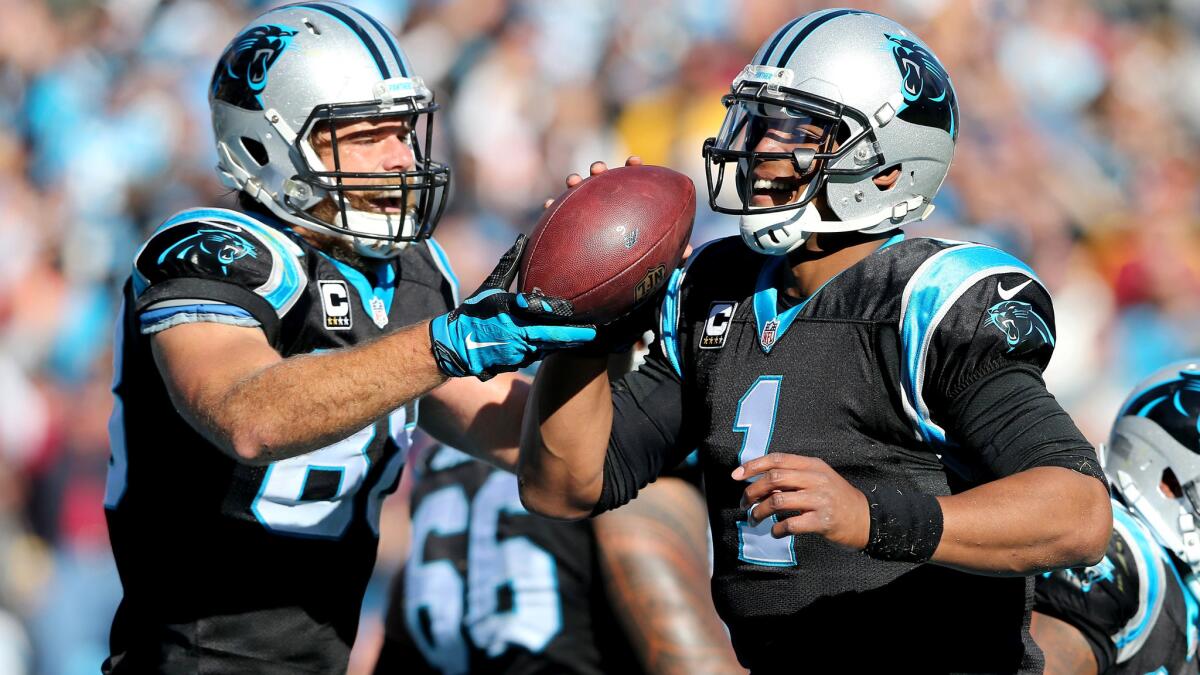 Panthers tight end Greg Olsen (88) and quarterback Cam Newton (1) celebrate after connecting on a touchdown pass against the Redskins in the first half Sunday.