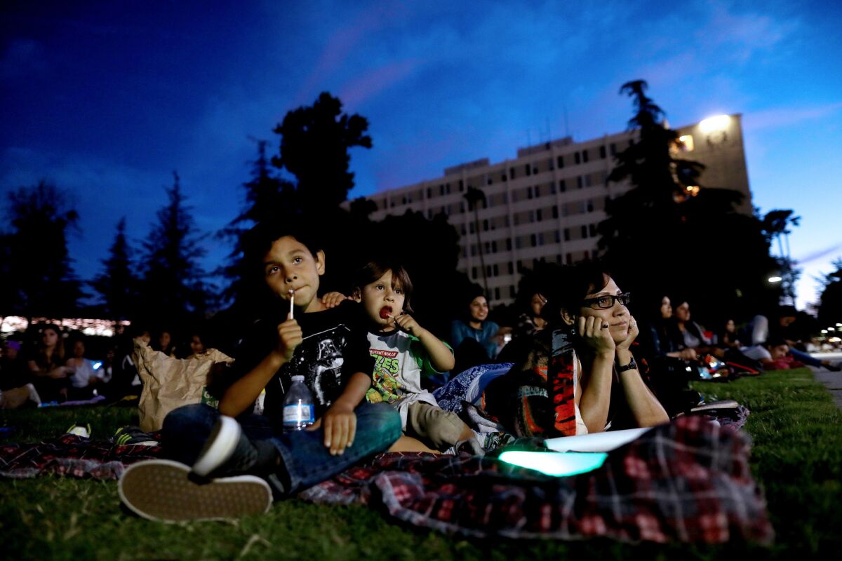 Sonia Montes of Sylmar and her children Jakob, 7, and Benjamin, 3, take in a showing of "The Incredibles" at Movie Fest on the CSUN campus.