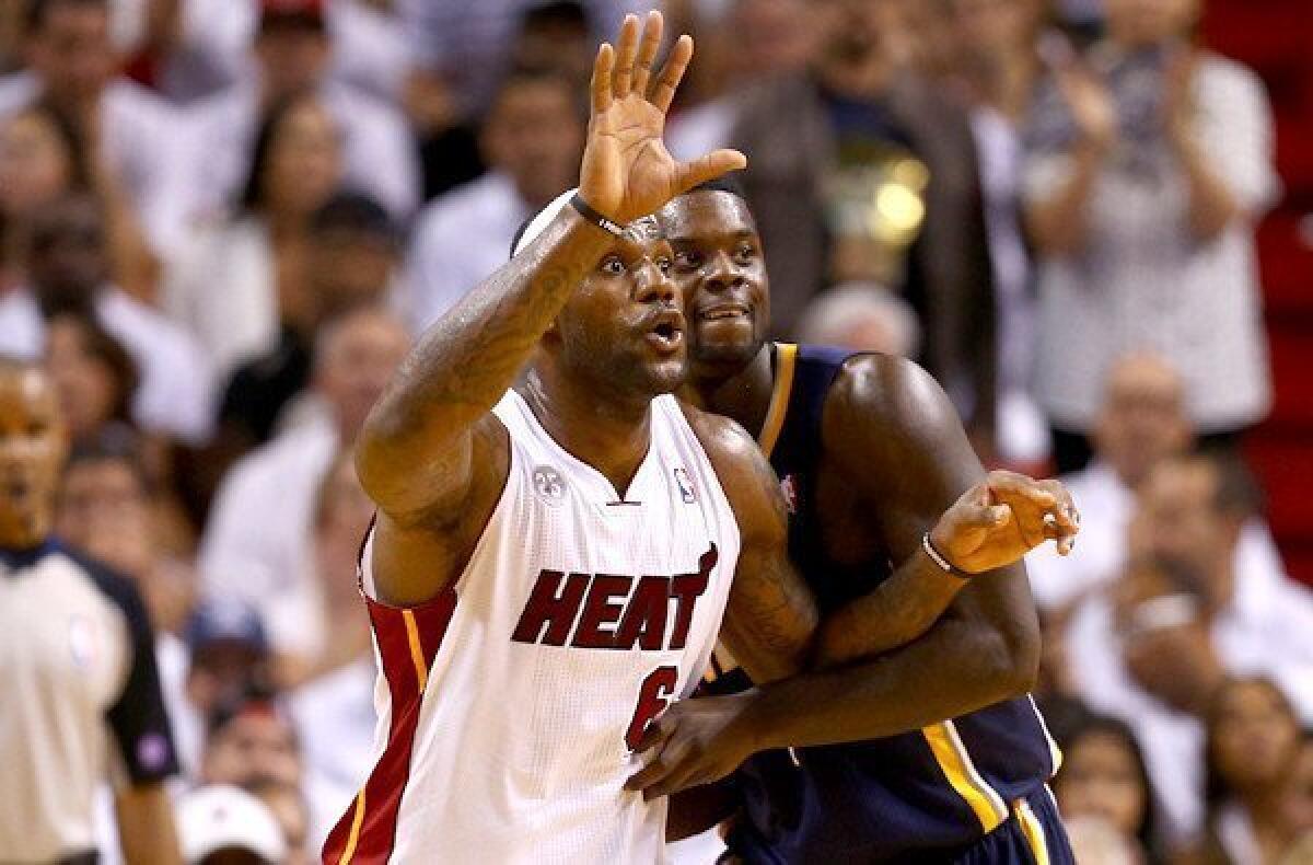 Heat forward LeBron James gains post position on Pacers guard Lance Stephenson in Game 5 on Thursday night.