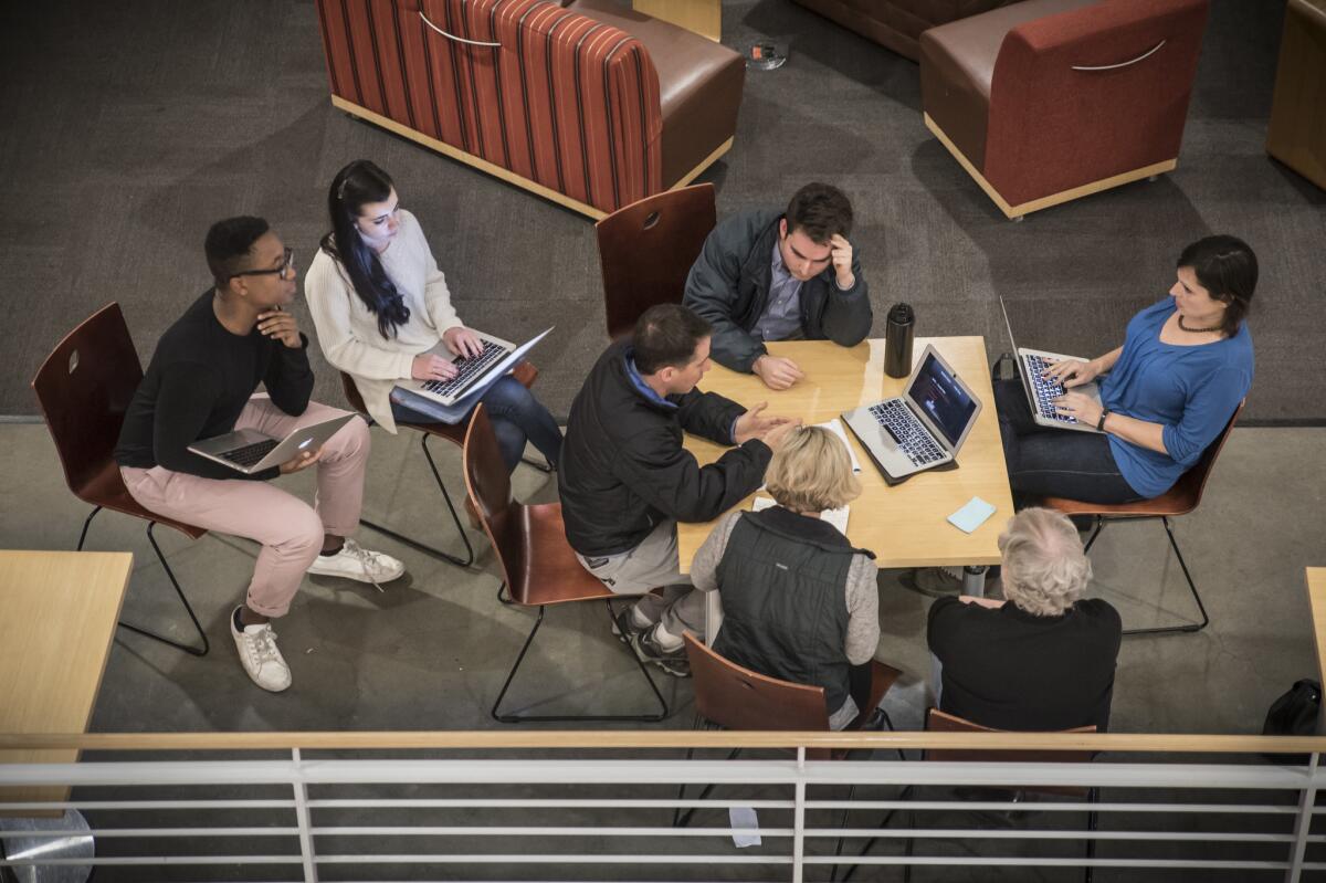 Students at Stanford University's Hacking 4 Diplomacy meet outside a classroom.