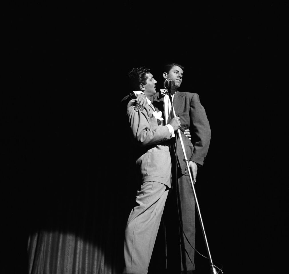 Dean Martin and Jerry Lewis perform on stage at the Paramount Theatre in July 1951 in New York City.