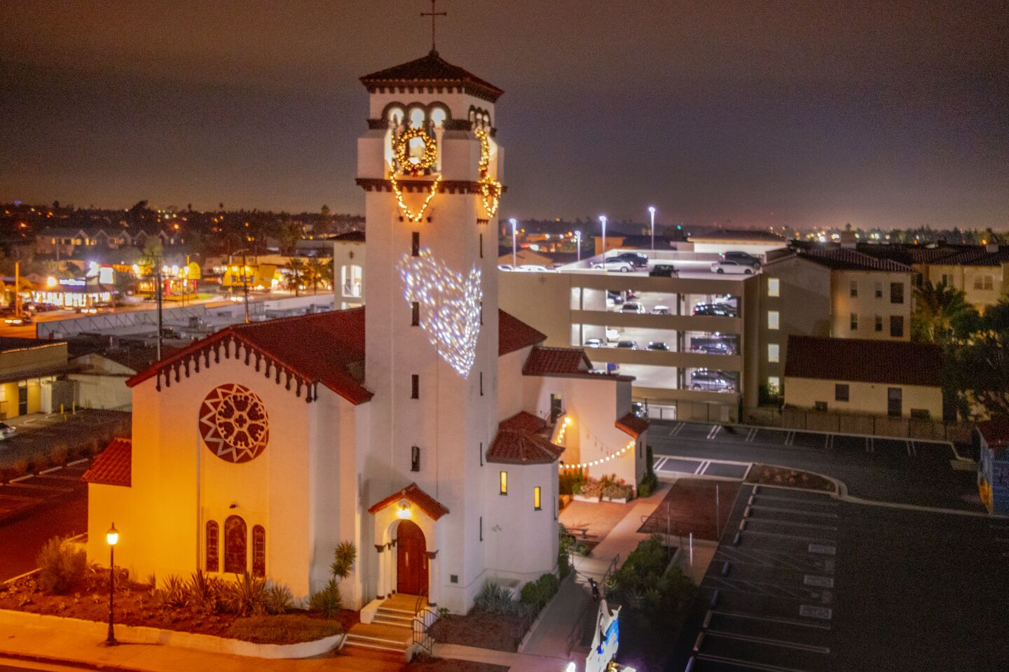 The 92-year-old bell tower at First United Methodist Church in Costa Mesa glows with Christmas lights Sunday night as part of the church's second annual Shine Bright festivities.