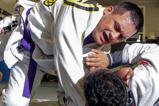 Jeff Mata, top, grapples with sparring partner Christian Lopez at the San Diego Brazilian Jiu-Jitsu Academy in San Marcos on Friday.