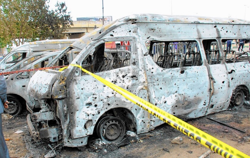 Burned vehicles sit at a bus station in Abuja, Nigeria, that was attacked April 14, apparently by the militant group Boko Haram. The suicide bombing killed 71 civilians.