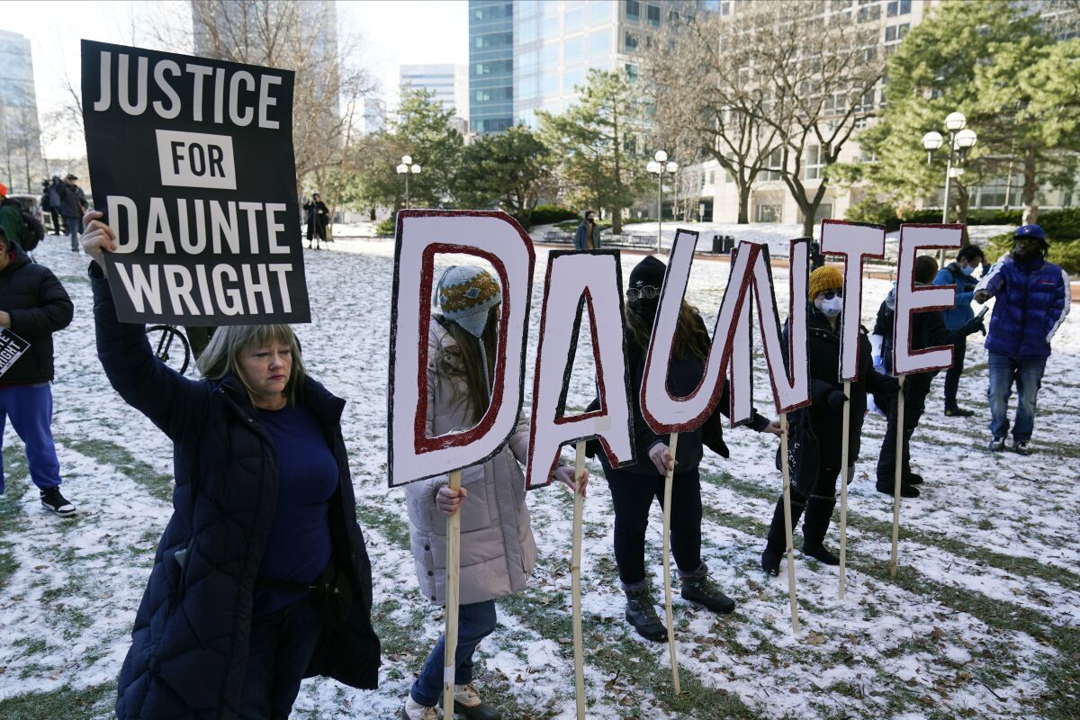 FILE - Demonstrators gather at the Hennepin County Government Center in Minneapolis where jurors found former suburban Minneapolis police officer Kim Potter guilty of first degree and second degree manslaughter in the death of motorist Daunte Wright on Dec. 23, 2021. Few Americans believe there has been significant progress over the last 50 years in achieving equal treatment for Black people in dealings with police and the criminal justice system. That's according to a new poll by The Associated Press-NORC Center for Public Affairs Research.(AP Photo/Jim Mone, File)